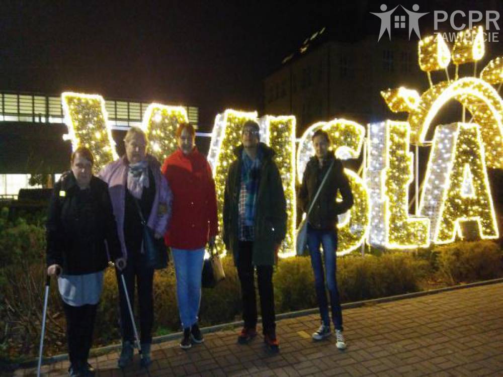 Zdjęcie: Grupa kobiet i mężczyzn na tle podświetlanych liter z napisem Wisła